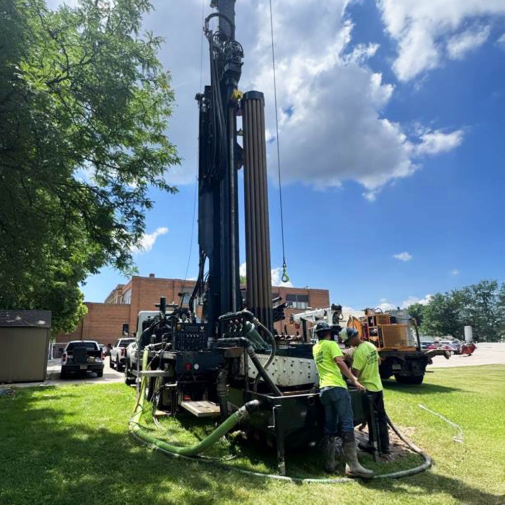 Bore Logic drilling technicians operating a hydraulic drill rig for geotechnical testing on a commercial site.