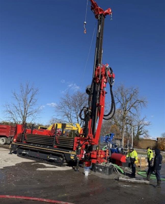 Fraste FS 250 geothermal drill rig being commissioned on a jobsite as a technician verifies hydraulic and control system setup.